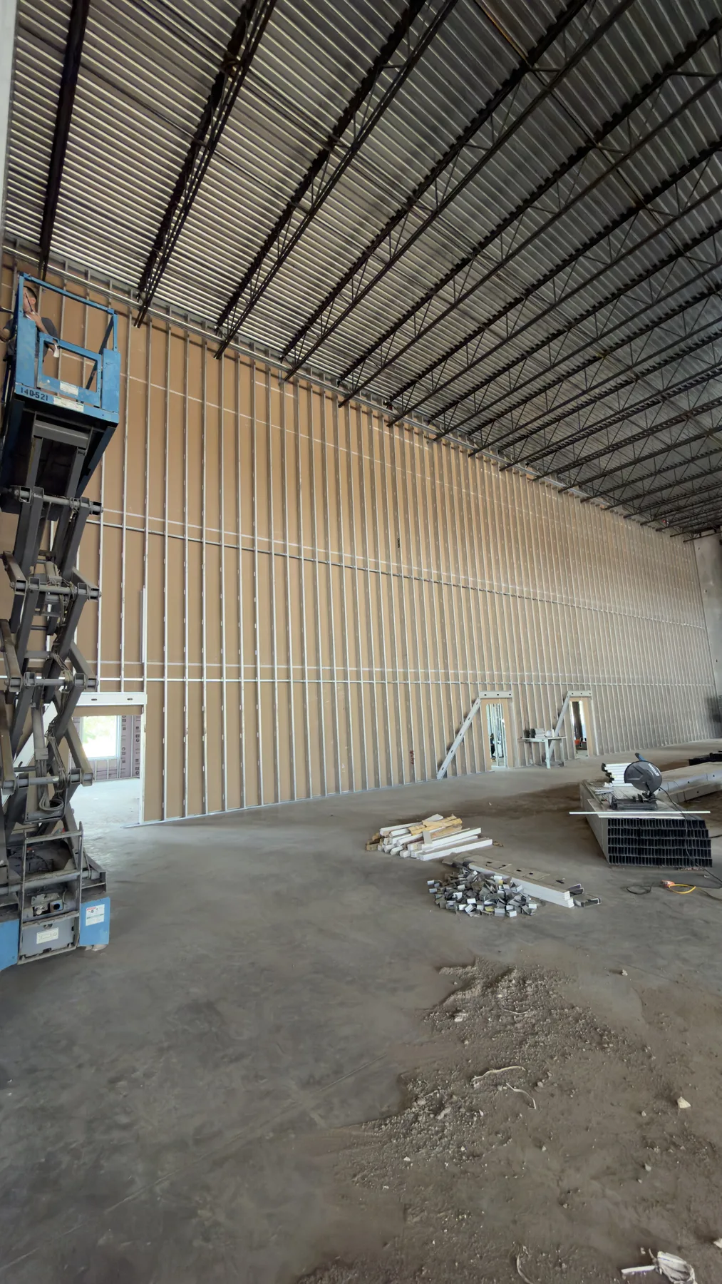 Tall commercial interior wall framed with steel studs