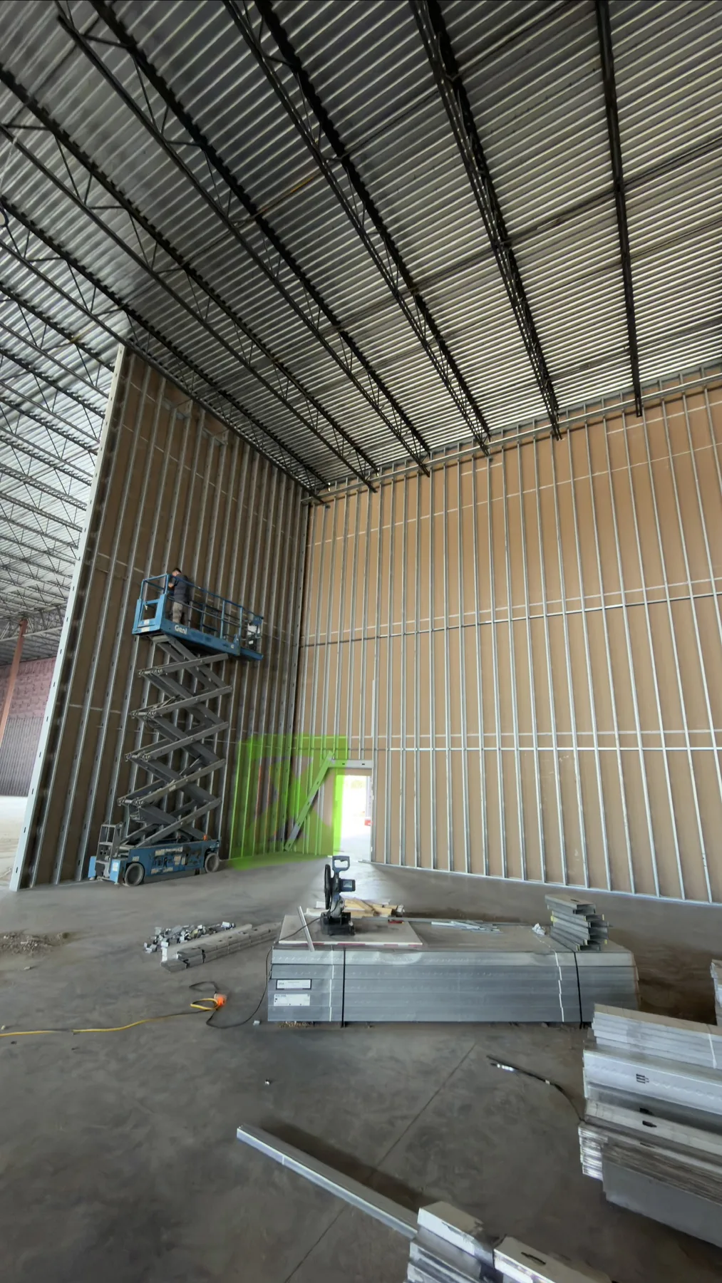 Tall commercial walls under construction with steel stud framing