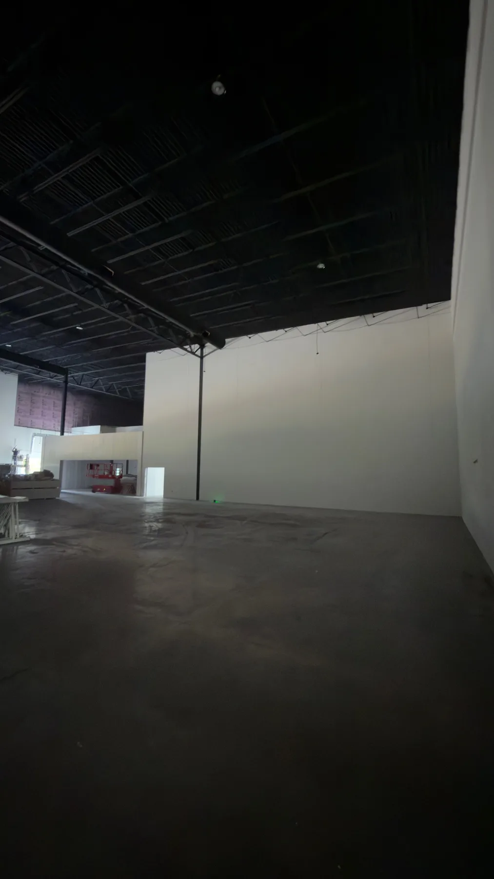 Large commercial interior with newly installed drywall surfaces